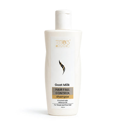 A white bottle of Titos Organic Goat Milk Hair Fall Control Shampoo on a clean white background.