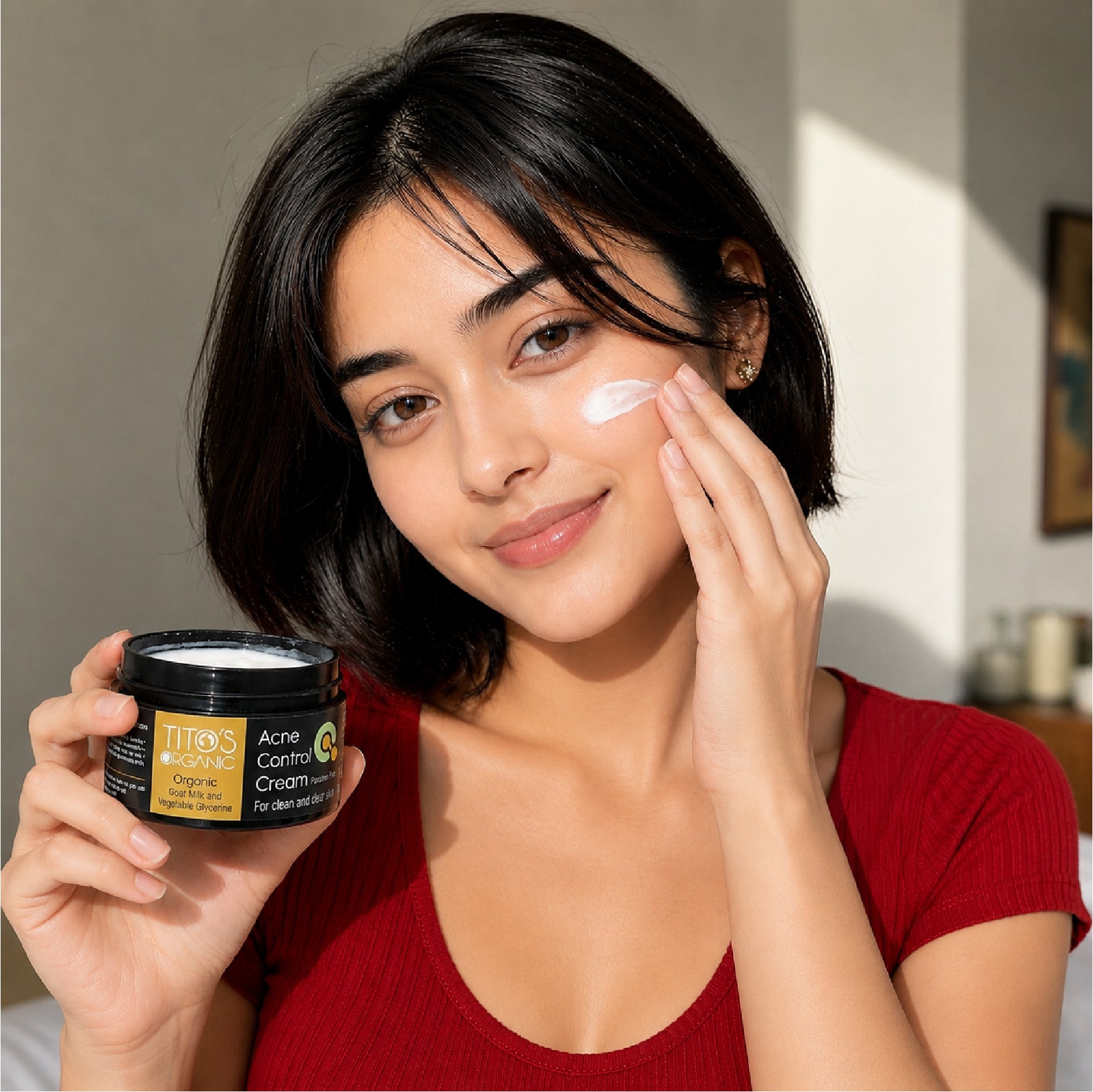Woman applying Tito’s Organic acne control cream on acne-prone skin