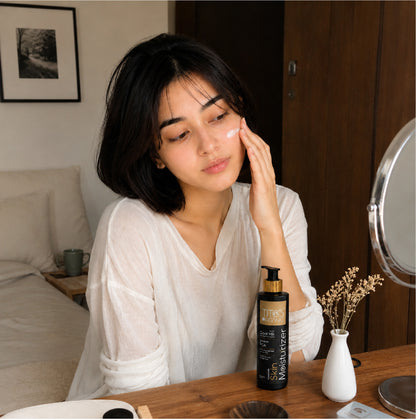 Woman applying Tito’s Organic Goat Milk Skin Moisturizer as part of daily skincare routine